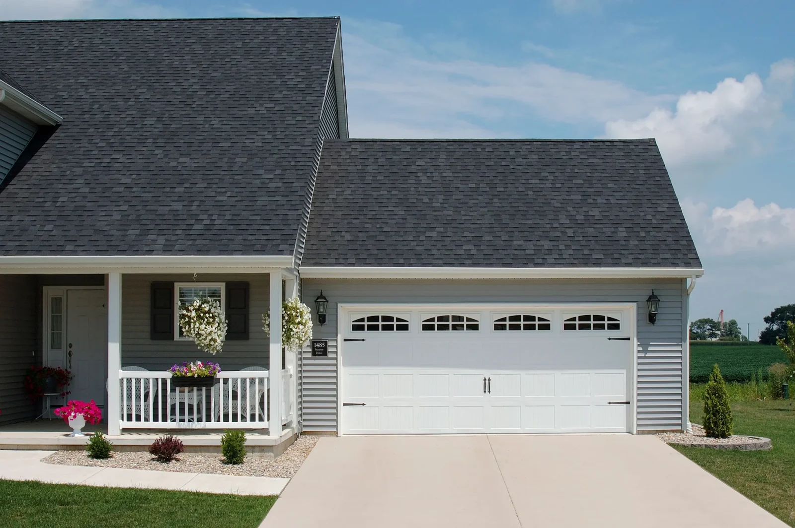 Real residential exterior with a white carriage-style garage door